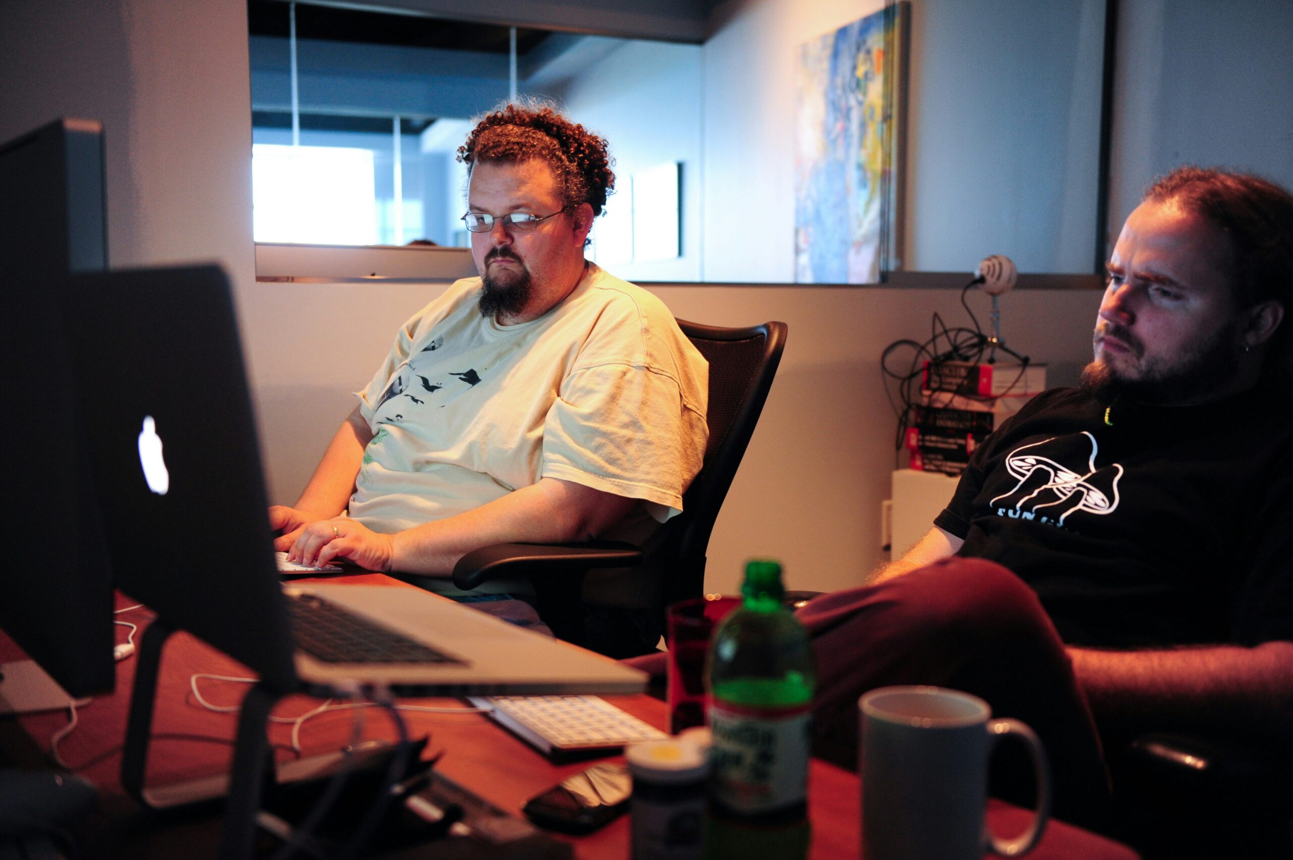 Two men creating automations on their computers